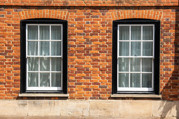 Old bricks wall in England with windows, England