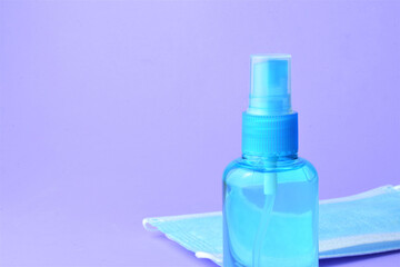 Close up, hygienic measures, hydroalcoholic gel and surgical masks, on a blue  background 