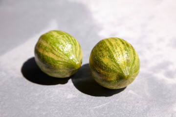 Striped lemons, Variegated pink lemons or pink-fleshed Eureka lemons on gray concrete table. Citrus fruits