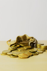 Close up , twenty cents euro coin, outline scattered with a small fabric bag in the background