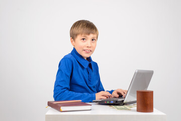 the young hacker: a Young smart boy with a netbook recklessly happy with his Affairs