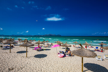 PLAYA DE MURO, Mallorca, Spain - 23 July 2020 - People enjoying hot summer day on popular city...