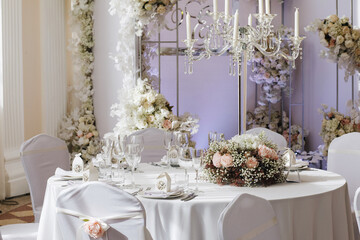 tableware Glasses, flower fork, knife served for dinner in restaurant with cozy interior