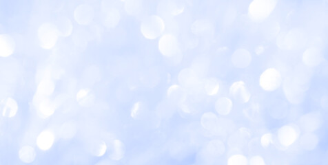 Bokeh light on blue background, sky with circle glitter light blue. Snow abstract soft glowing with vivid bright light and bokeh blur effect. 