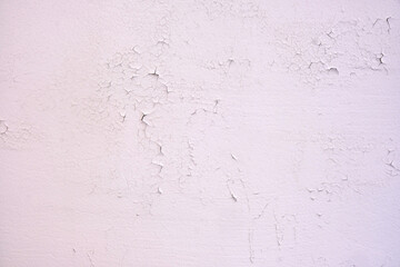 Cracked new paint on a white wall, background of fresh paint close-up
