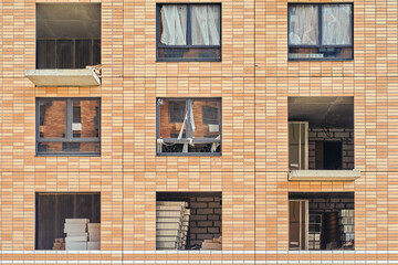 Facade with windows of a building under construction, close-up