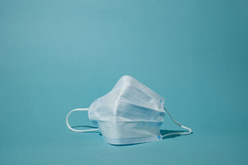 surgical face mask on blue background for new normal life.