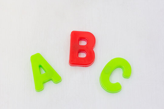 Letters abc on white background. learning alphabet with plastic toy, english language school