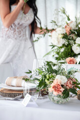 wedding table setting with wedding dress in the background