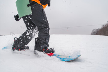 man snowboarding down by hill