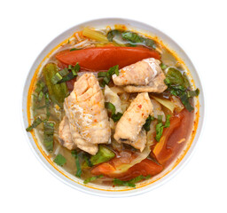 Bowl of spicy seafood soup on white