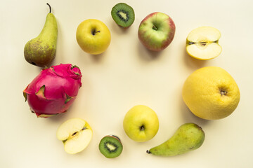 A variety of colourful fresh fruit on a yellow background shot from above with copy space