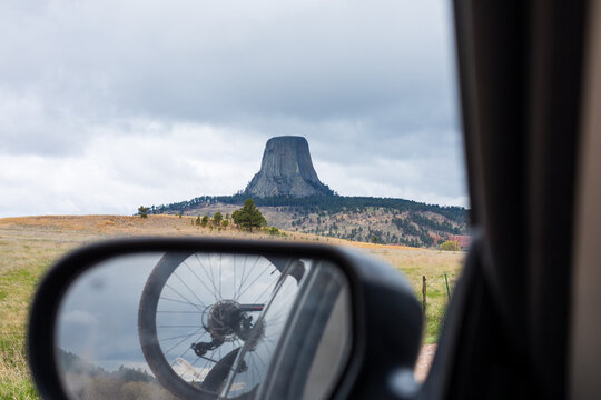 Bicycle tyre and landscape reflection in a car wing mirror, Devil's Tower, Wyoming, USA