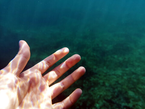 Close-up of a woman's hand underwater in sea, Bugibba, Malta