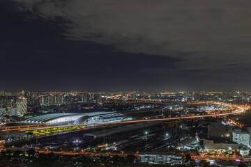 Naklejka premium Bangkok, thailand - Aug 28, 2020 : Aerial view of Bang Sue central station with skyscrapers background at night. Selective focus.
