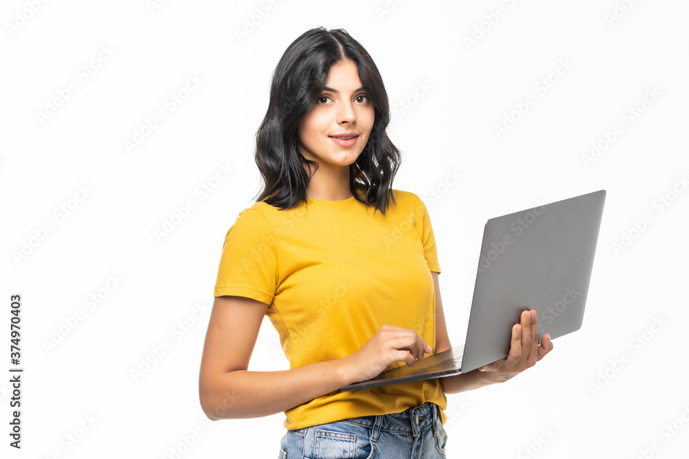 Wall mural young smiling confident woman using laptop and looking camera isolated over white