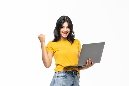 Young success girl on a laptop isolated over a white background