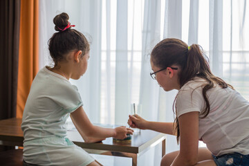 two girls eat in a hotel room