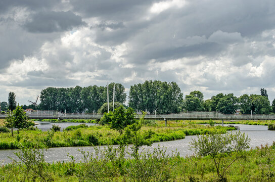 Hardenberg,The Netherlands, July 28, 2020: view across the park in the floodplains of the river Vecht towards the princess amalia bridge for pedestrians and cyclists