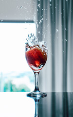glass of water with apple splashing