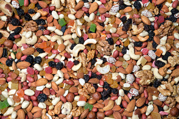 A mixture of nuts, dried fruits and candied fruits as a colorful background of natural products.
