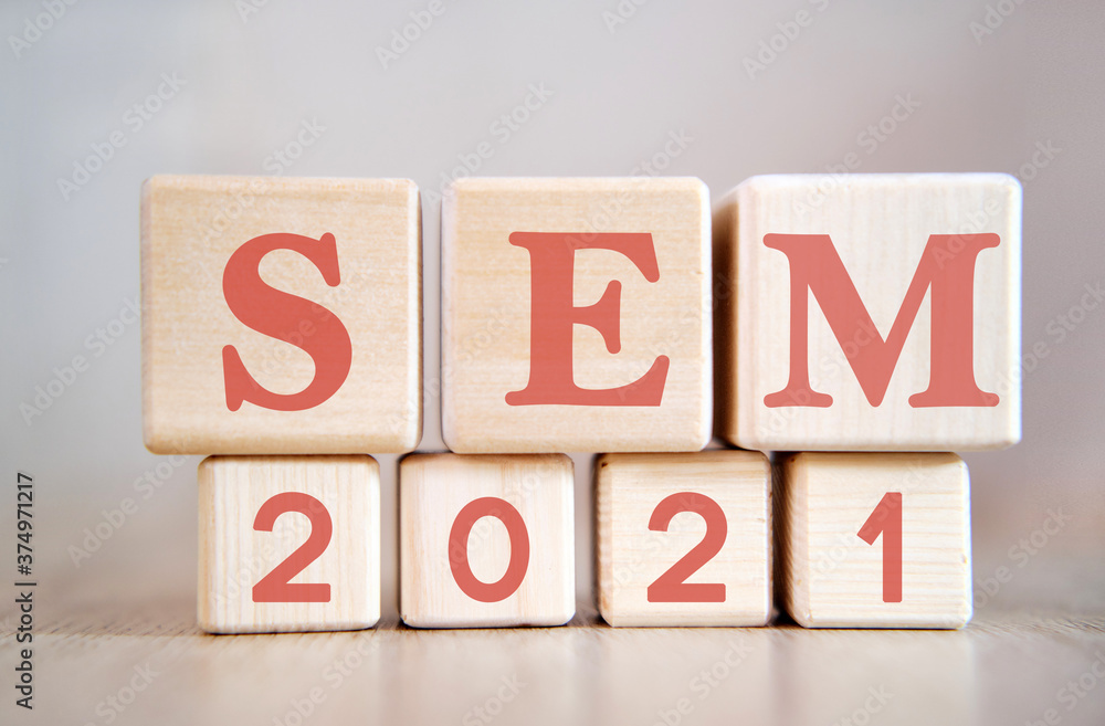 Poster sem 2021 text on wooden cubes on a monochrome background with reflection.