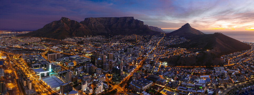 Panoramic aerial view of Cape Town surrounded by mountains at night, South Africa