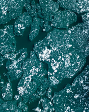 Aerial view of beautiful patterns created by frozen ice on turquoise lake M&radic;&deg;svatn in North Iceland.