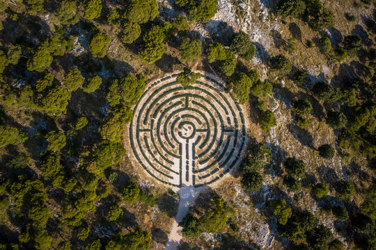 Aerial view of a labyrinth shaped garden surrounded by trees in Rogoznica, Croatia