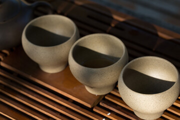Ceramic bowls made of clay on a wooden background.