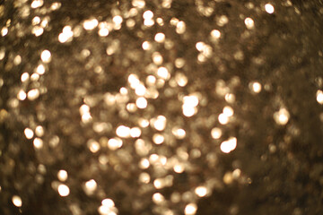 Shiny abstract gold background out of focus.