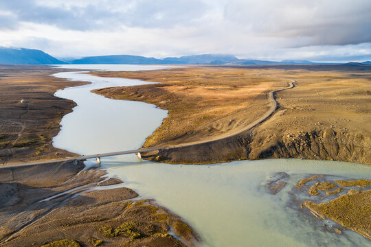 Aerial view of the Kjolur 4WD road through the highlands, with bridge over river Hvita and lake Hvitarvatn in the last sunlight of the day, Iceland
