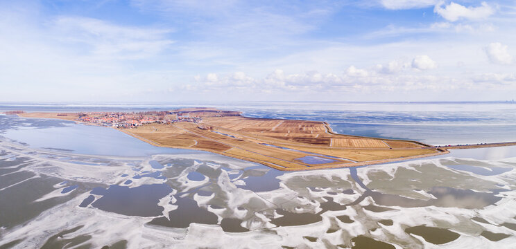 Panoramic aerial view of the island / peninsula of Marken between the frozen Gouwzee and Markermeer after a long period of frost in February 2018, Noord-Holland, Netherlands