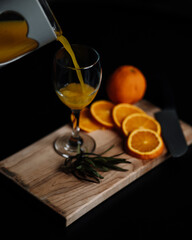 cup with orange juice on little table