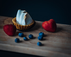 lemon pie strawberries and blueberries in table