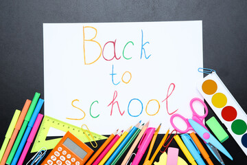 Different school supplies with text Back to School on black background