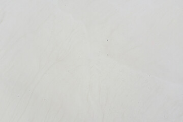 Natural gray background of the salt surface of the reservoir. Texture. Shooting from a drone.