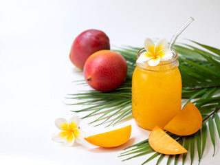Fresh mango juice in the jar on the white background. Tropical fruit concept.