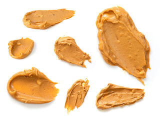 Creamy peanut butter isolated on white background.  Copy space. Top view.