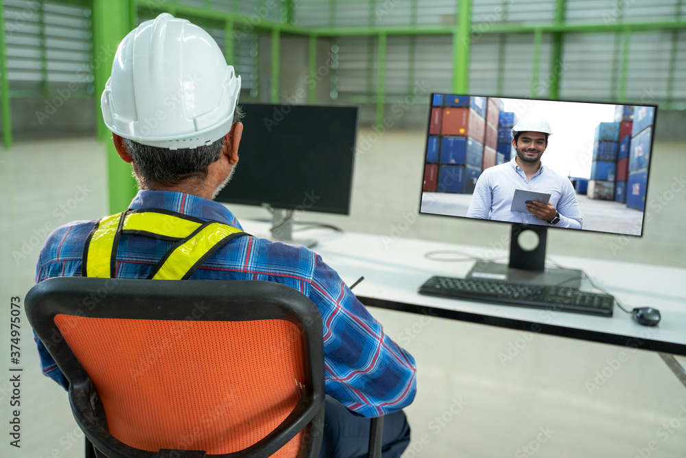 Poster Warehouse worker talk brainstorm on video call on computer with diverse colleagues in a large warehouse.