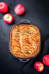 Traditional French apple tarte offered as top view on a design cast iron pan