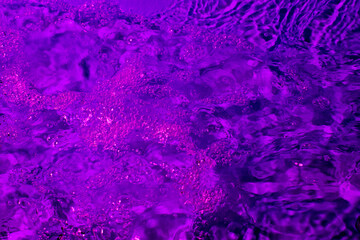 splash of water in lilac light. Abstract wallpaper