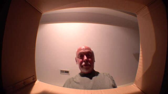 POV opening carton box delivery on quarantine gift purchase. Male looking in box and happy to receiving products. Home isolation happy smiling after courier e-commerce delivery