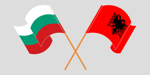 Crossed and waving flags of Albania and Bulgaria