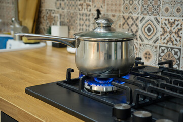 Cooking on a gas stove. The pot on gas burner.