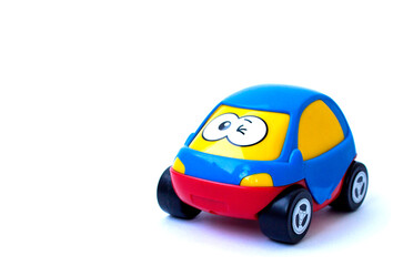 Children's toy. Blue car with eyes. Wink. Isolate. High quality photo