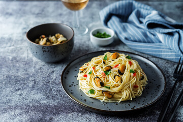 Mussel pasta with pepper and parsley in a plate