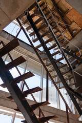 Obraz premium Interior of a construction site of a multi-storey building. Installation of steel stairs using steel i-beams.