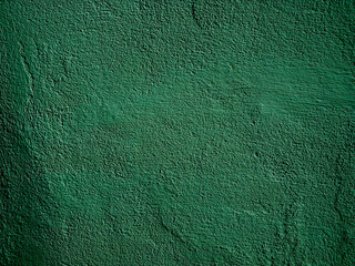 Green concrete wall is a decorative or textured surface. Can be used as a background or for design purposes