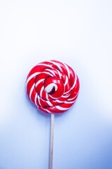 Sweet candy round red and white lollipop on a white background